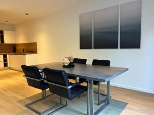 a dining room table with chairs and a kitchen at Heide-Liebe in Soltau +6 photos
