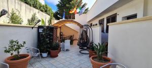 a courtyard with potted plants on a building at Sea and Blue Sky 1B-2 in Calimera