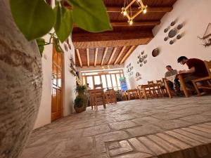 two men sitting at a table in a restaurant at Sarrafon Guest House in Bukhara