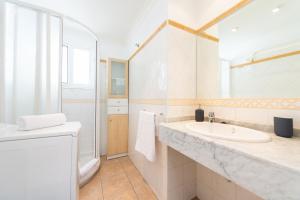 ein weißes Badezimmer mit Waschbecken und Toilette in der Unterkunft Las Adelfas South Beach 5 By CanariasGetaway in San Bartolomé de Tirajana + 25 Fotos