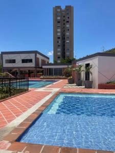 a swimming pool next to a building at Para estrenar agradable apartamento acogedor in Cúcuta