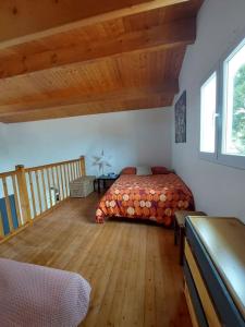 a bedroom with a bed and a wooden floor at Maison 12 pers, Le Phare - 300 mètres des plages in La Tranche-sur-Mer