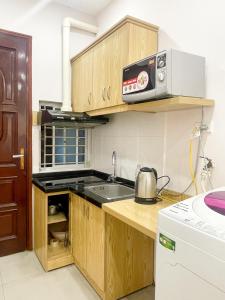 a small kitchen with a sink and a microwave at Joy Homestay in Hanoi +16 photos