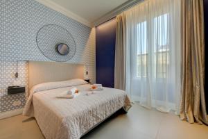 Postel nebo postele na pokoji v ubytování Seven Suites Apartments - Via Matteotti 178