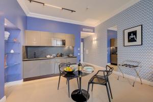 a kitchen with a table and chairs in a room at Seven Suites Apartments - Via Matteotti 178 in Sanremo +94 photos