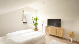 a bedroom with a bed and a flat screen tv at 3,5-Zimmer inkl Arbeitsplatz, WLAN & free Netflix, Amazon-Free Parken vollausgestattete Wohnung, 24h Check In in Hamm