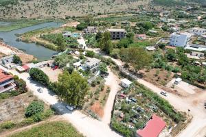 an aerial view of a town next to a river at Garden Lake Camping in Ksamil
