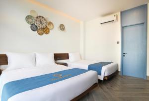 Postel nebo postele na pokoji v ubytování Velar Hotel Con Dao - Vung Tau