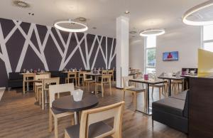 Uma TV ou centro de entretenimento em Star G Hotel Premium München Domagkstraße