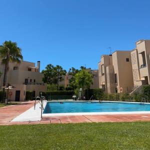 a swimming pool in front of some buildings at Costa Ballena Mar Abierto in Costa Ballena