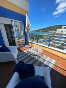 a living room with a view of the ocean at Apartamento con vistas al mar B5 Urb Puerto Azul in Cedeira