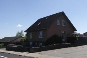 a brown brick house with a black roof at Vejle Apartment Skovhøjen in Vejle