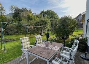a table and chairs on a patio with a swing at Ferienhaus Rosswangen in Balingen