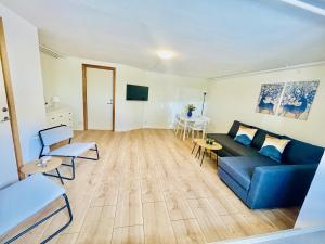 a living room with a blue couch and a table at aday - 2 Bedroom apartment close to Aalborg Hospital in Aalborg
