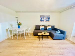 a living room with a couch and a table at aday - 2 Bedroom apartment close to Aalborg Hospital in Aalborg