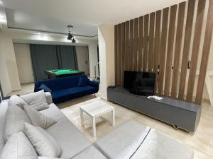 a living room with a couch and a tv at Moubark 6 Villa 1 in Hurghada