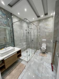 a bathroom with a shower and a toilet and a sink at Moubark 6 Villa 1 in Hurghada