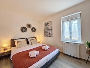 - une chambre avec un lit et 2 serviettes roses dans l'établissement Joli studio Le Rosa Bonheur, proche de la gare, à Yzeure