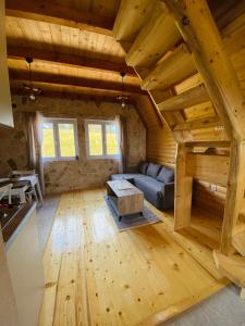 a living room with a couch and a table in a cabin at Red Rock in Žabljak