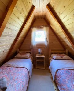 a bedroom with two beds in a log cabin at Red Rock in Žabljak