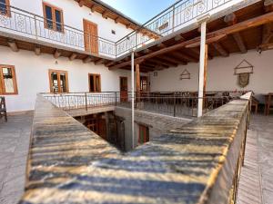 a building with a pier in front of it at Sarrafon Guest House in Bukhara
