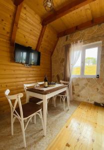 a dining room with a table and chairs in a cabin at Red Rock in Žabljak