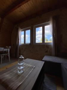 a glass vase sitting on a table in a room with windows at Red Rock in Žabljak +21 photos