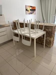 a white table and chairs in a kitchen at CASA JAGGER in Costa Calma