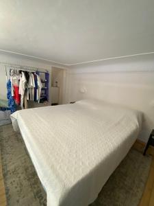 a bedroom with a large white bed and a closet at margherita house in Avola