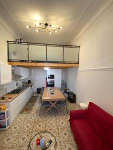 a living room with a table and a kitchen at margherita house in Avola