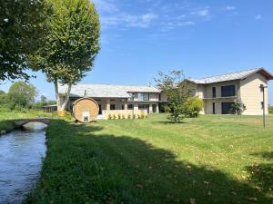 a house with a river in front of it at CASA VOLA in Cuneo