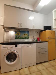 a kitchen with a washing machine and a washer at Apartments Jessica in Krk