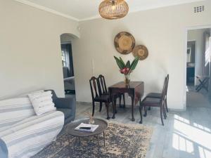 a living room with a couch and a table at Whitehouse cottage in White River