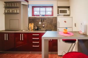 a small kitchen with a counter and a table at Penzion Charlie in Mohelnice