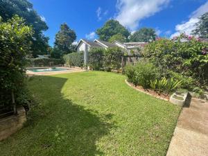 a yard with a house and a swimming pool at Whitehouse cottage in White River