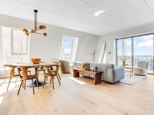 a living room with a table and a couch at Sanders View Copenhagen - Stunning Two-Bedroom Apartment with harbor view in Copenhagen