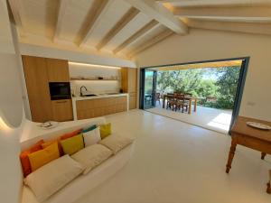 a living room with a couch and a table at Newly renovated traditional Sardinian dwelling in Porto Rotondo