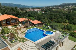 an aerial view of a house with a swimming pool at Fernandes Guest house Yellow Bungalow in Ponte de Lima +25 photos