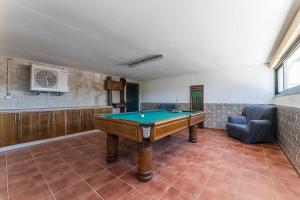 a room with a pool table and a couch at Fernandes Guest house Yellow Bungalow in Ponte de Lima