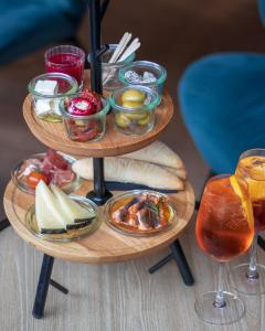 two wooden plates of food on a table with drinks at Crowne Plaza Berlin City Centre Ku'damm, an IHG Hotel in Berlin