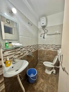 a bathroom with a sink and a toilet at Sober 2bhk Pet Friendly Apartment with pool view in Marmagao