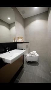 a bathroom with a sink and a toilet at 8 Kia Peng Central Suites in Kuala Lumpur