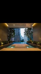 a large swimming pool with a view of a city at 8 Kia Peng Central Suites in Kuala Lumpur