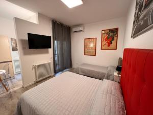 a bedroom with a bed and a flat screen tv at 10 Minutes B&B Bed & Breakfast in Verona