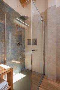a shower with a glass door in a bathroom at B&B Le Molinare Home Relax in Varda