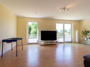 an empty living room with a flat screen tv at Großzügige Ferienwohnung im Haus ''Anno 2000'' in Bergen auf Rügen