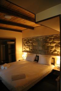 a bedroom with a large bed with two white pillows at Kadori Hills in Tʼelavi