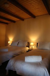 two beds in a room with two lamps at Kadori Hills in Tʼelavi
