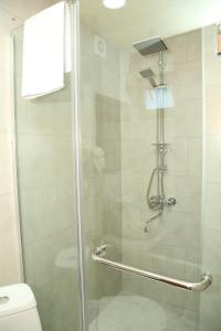 a shower with a glass door and a toilet at Kadori Hills in Tʼelavi