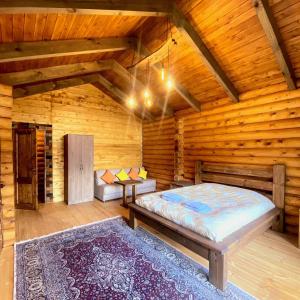 a bedroom with a bed in a wooden cabin at Arte Jermuk Cottages in Jermuk